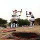 Image for article titled Saudi men fly through the air firing their rifles in stunning photos